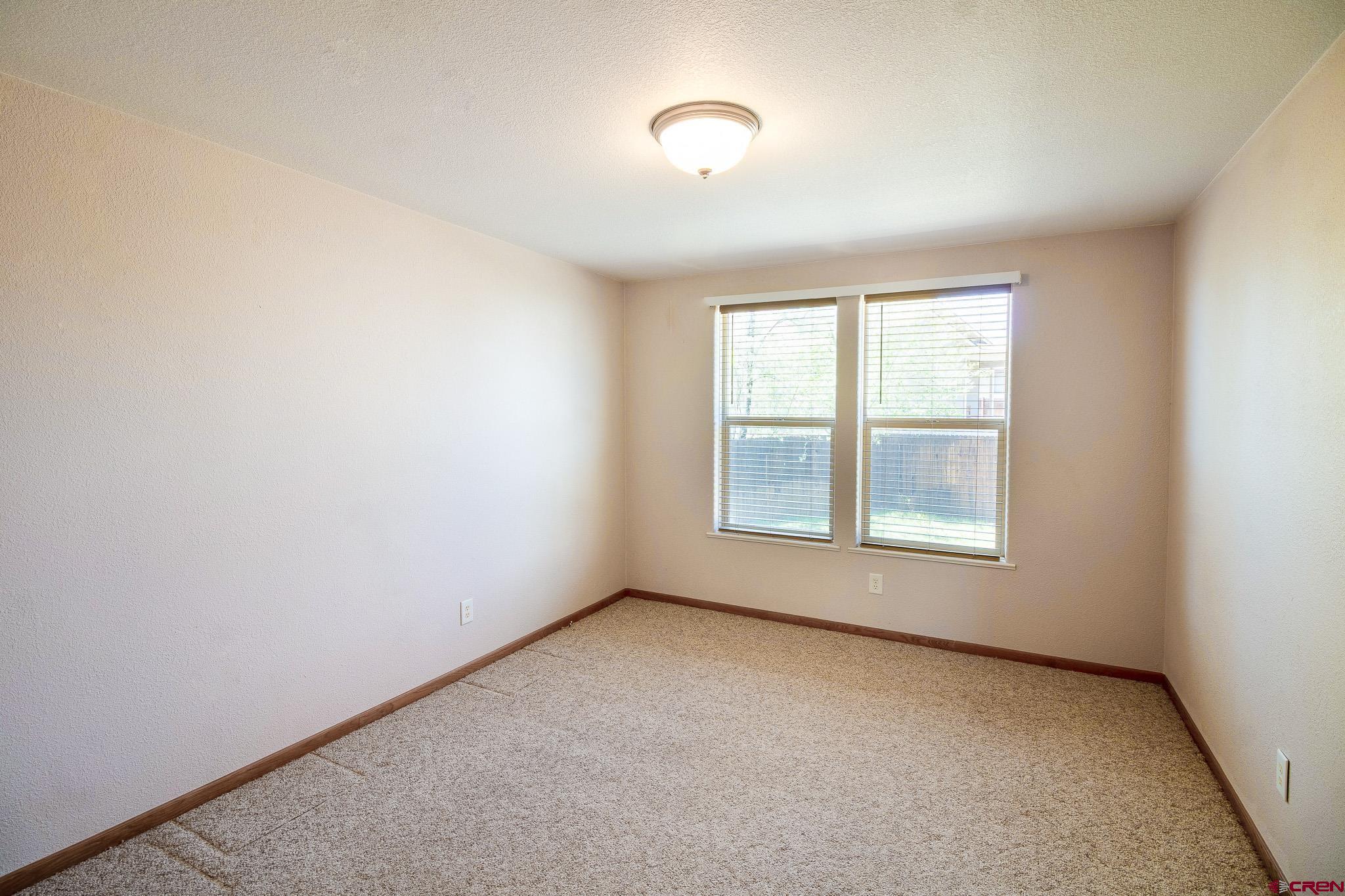 801 L Way Cortez, CO 81321 - Photo 14 of 41 an empty room with a window