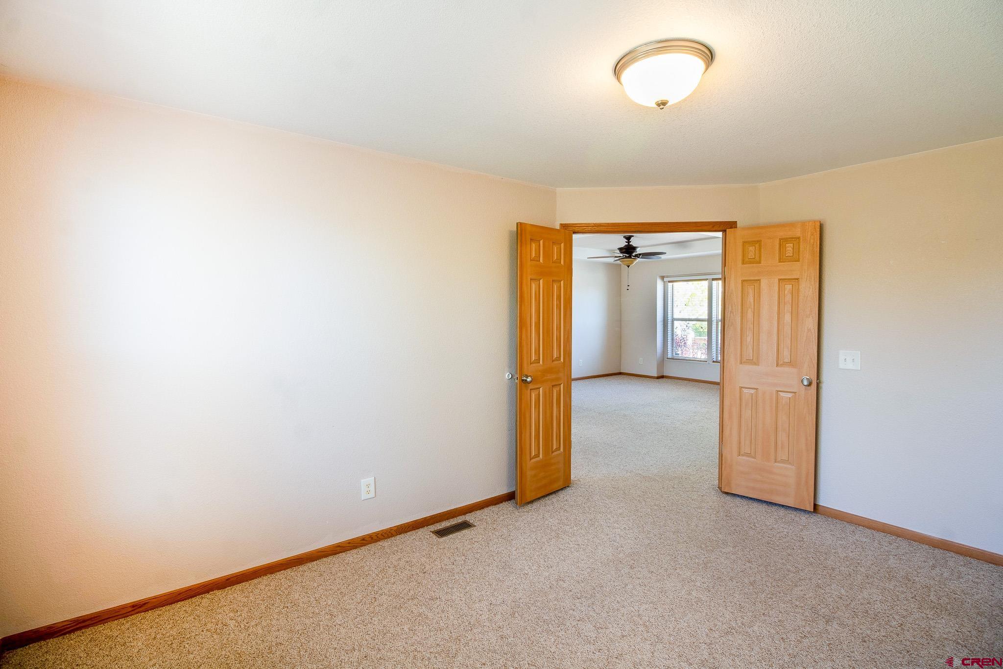 801 L Way Cortez, CO 81321 - Photo 15 of 41 an empty room with closet and wooden door