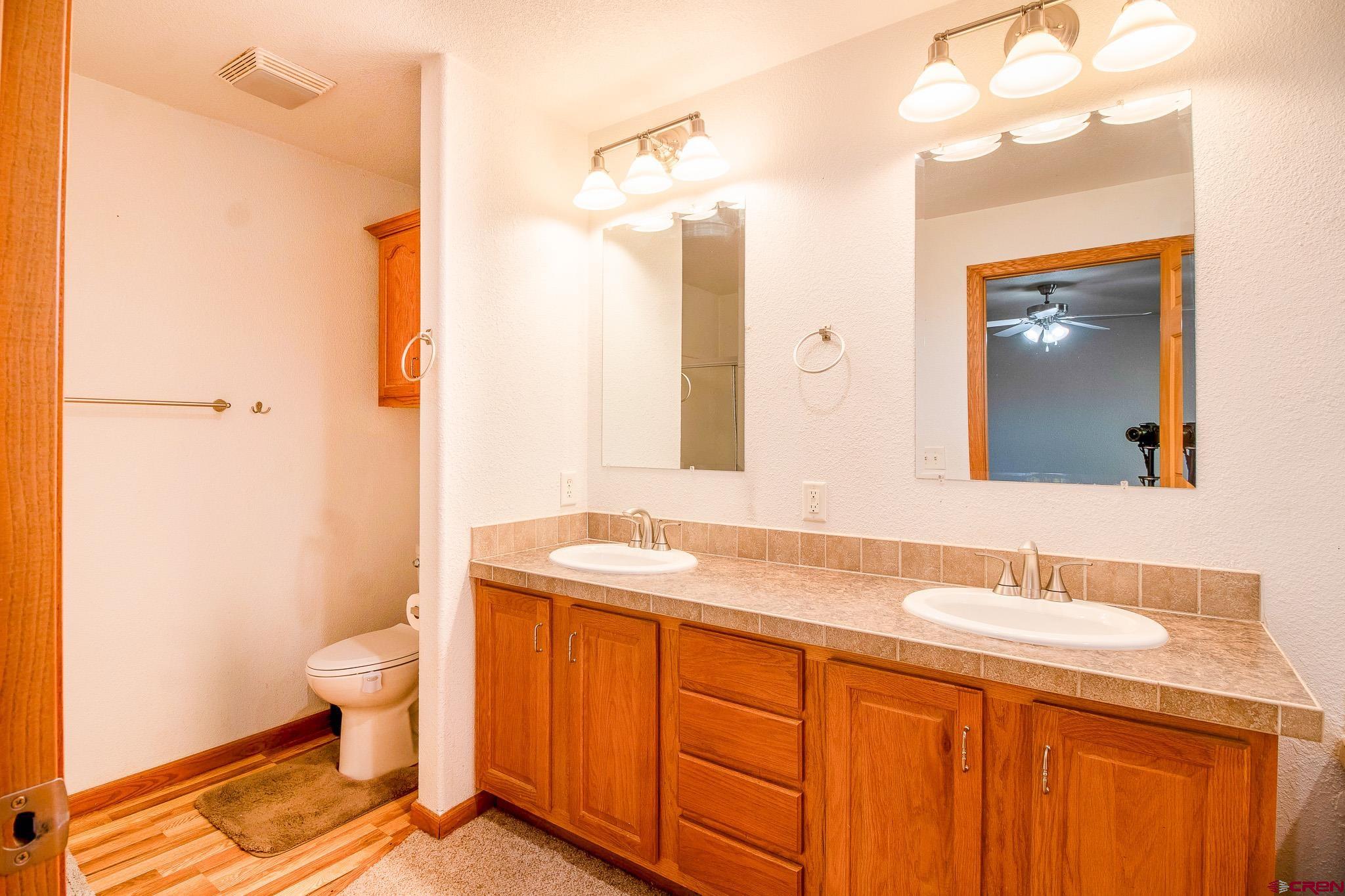 801 L Way Cortez, CO 81321 - Photo 18 of 41 a bathroom with a sink a toilet and a mirror