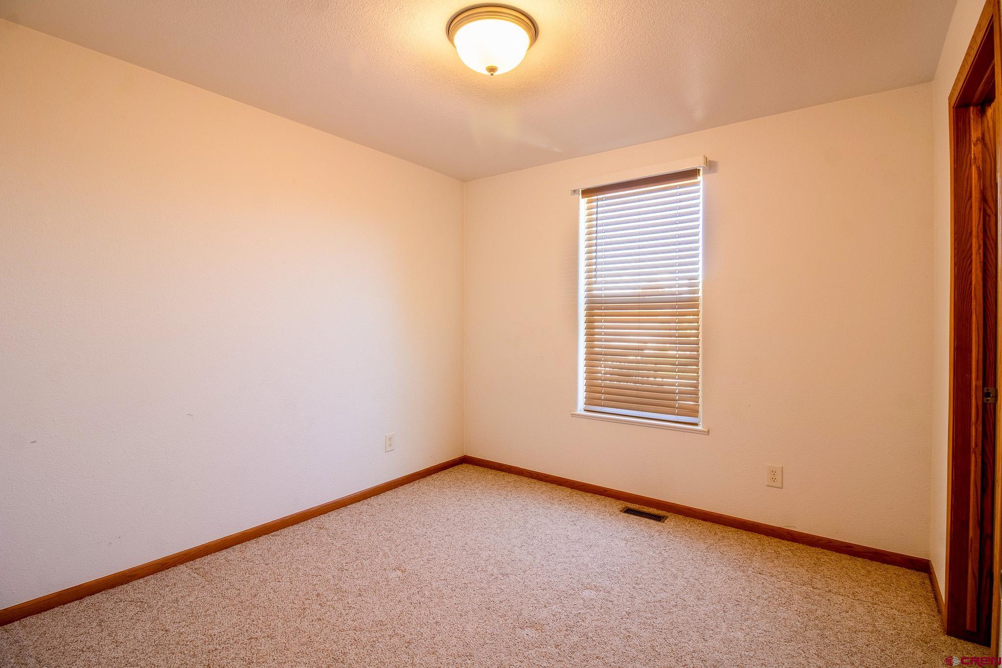 801 L Way Cortez, CO 81321 - Photo 21 of 41 an empty room with a window