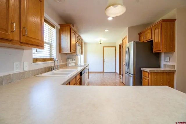 a kitchen with stainless steel appliances a refrigerator and a sink
