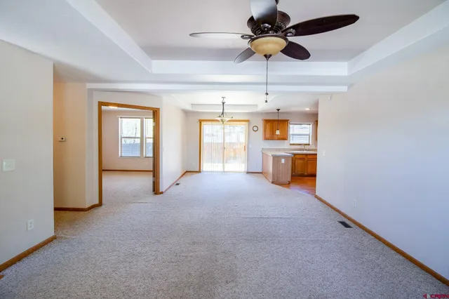a open kitchen with stove and white cabinets