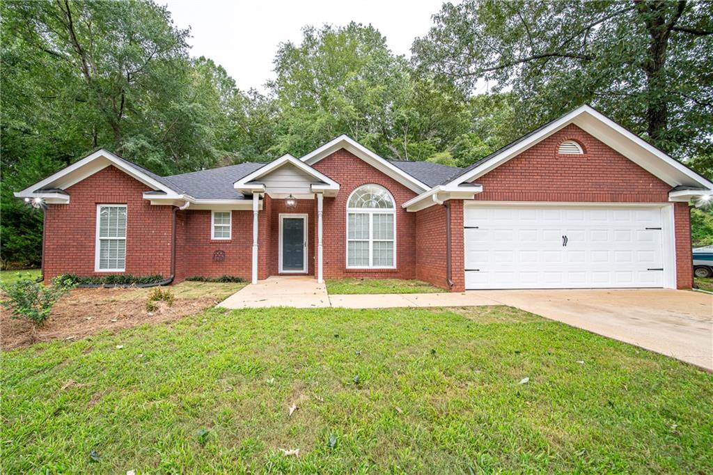 1927 Lee Road Salem, AL 36874 - Photo 3 of 45 Ranch-style home featuring a front lawn, driveway, a garage, a shingled roof, and brick siding