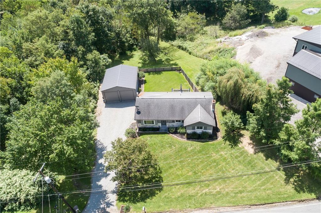 1420 Reissing Road McDonald, PA 15057 - Photo 33 of 33 This aerial view of the front of the home shows the entire property layout from above. The rooflines, driveway, front yard and landscaping are shown. Garage placement, surrounding trees and a little bit of the adjacent property will give you a good perspective of how the home sits within its environment.