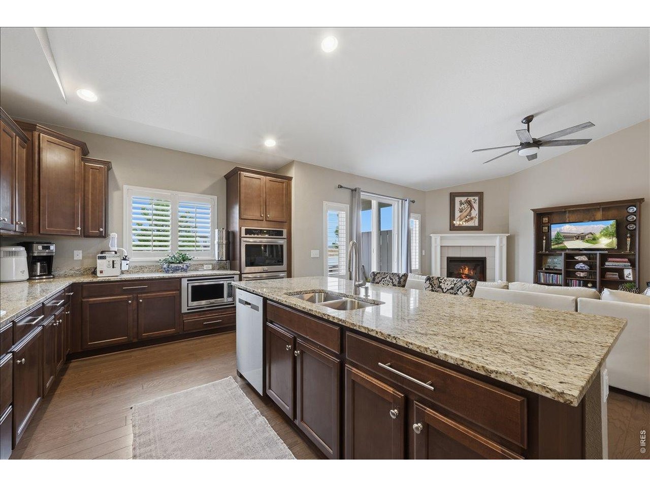 6096 Story Road Timnath, CO 80547 - Photo 13 of 50 a kitchen with granite countertop lots of counter top space sink and refrigerator