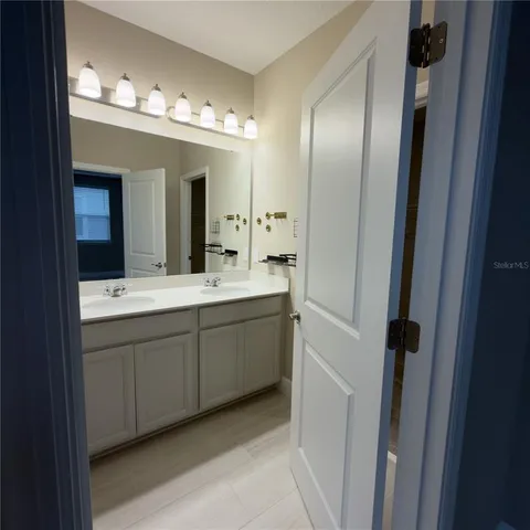 a bathroom with a glass shower door