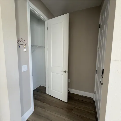 a view of a hallway with wooden floor