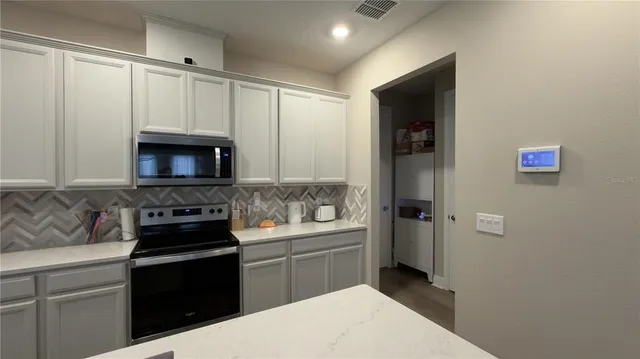 a kitchen with a sink and a stove top oven