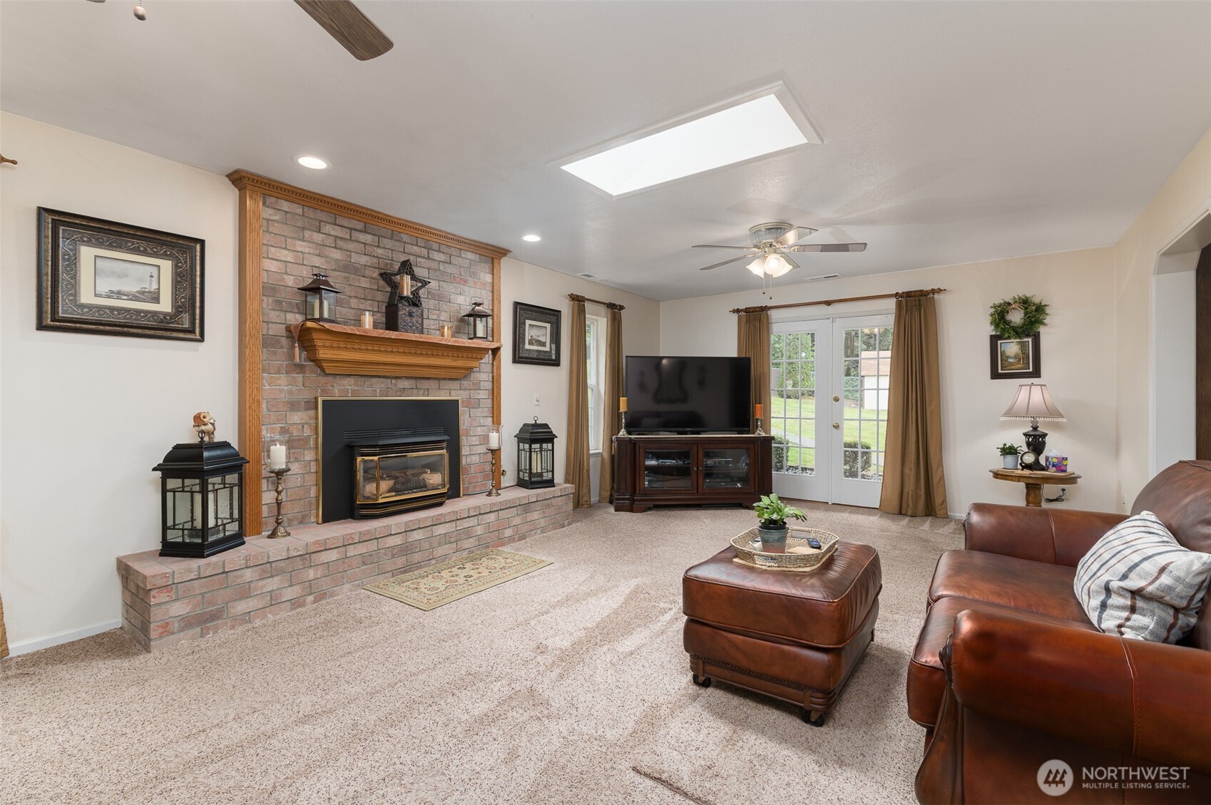 5860 Bell Creek Road Deming, WA 98244 - Photo 13 of 39 a living room with furniture a flat screen tv and a fireplace