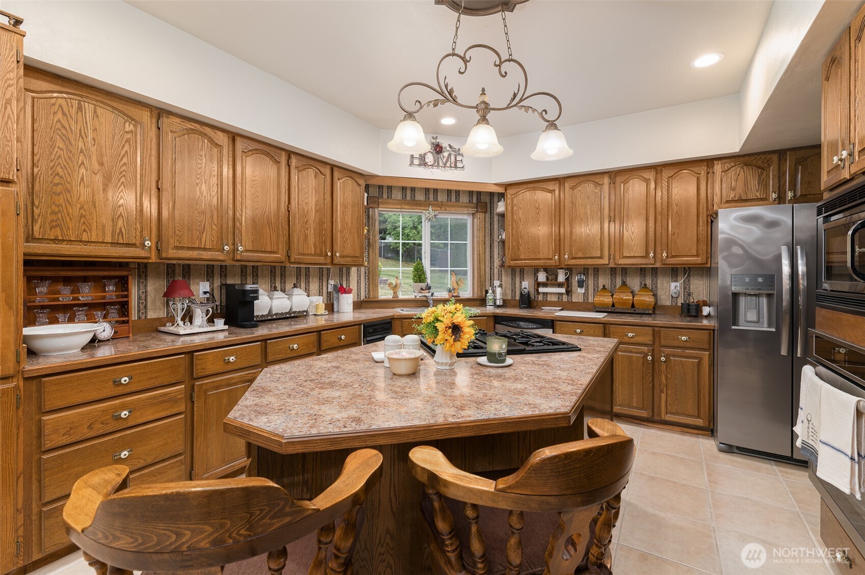 5860 Bell Creek Road Deming, WA 98244 - Photo 16 of 39 a kitchen with stainless steel appliances granite countertop a stove a refrigerator a kitchen island a table and chairs