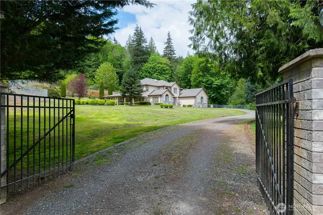 a view of a backyard with wooden fence