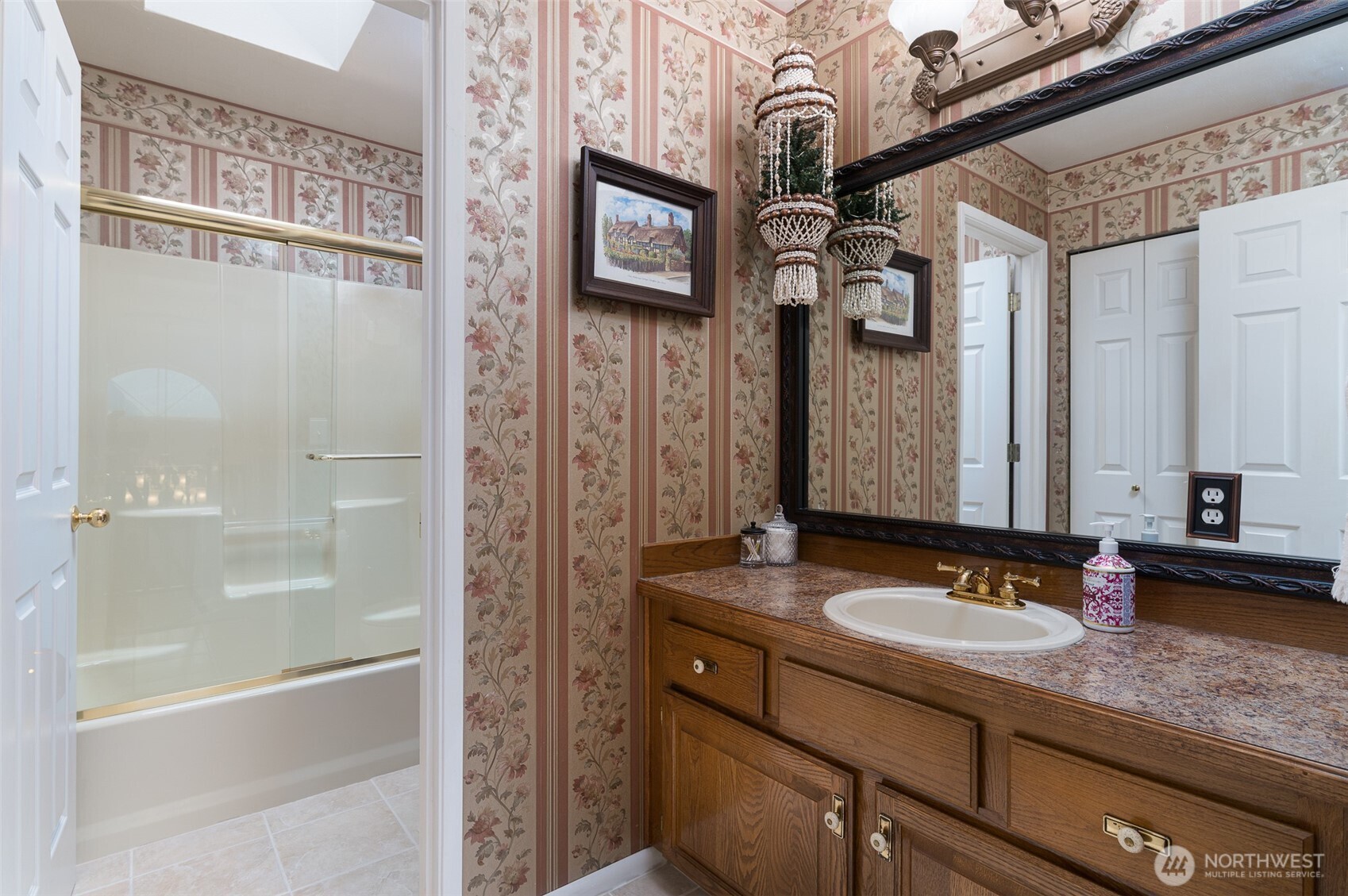 5860 Bell Creek Road Deming, WA 98244 - Photo 22 of 39 a bathroom with a granite countertop sink a mirror and a shower