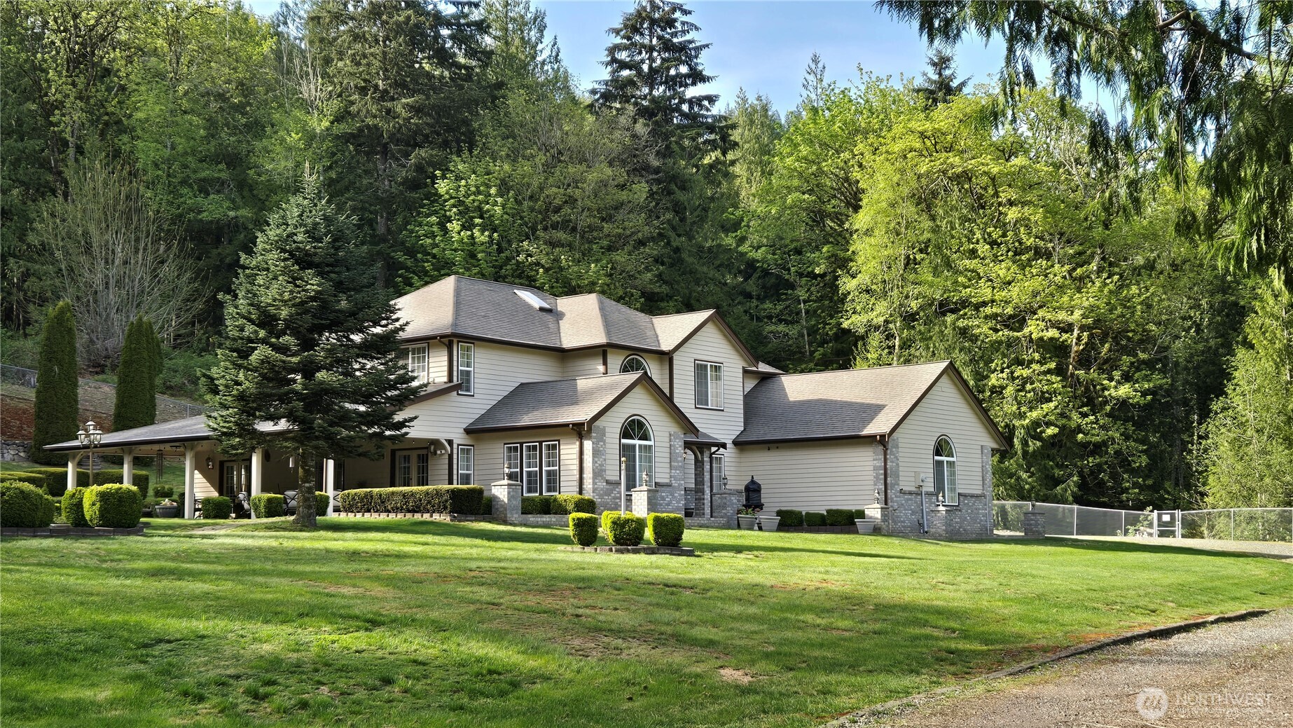 5860 Bell Creek Road Deming, WA 98244 - Photo 3 of 39 a view of a big house with a big yard and large trees