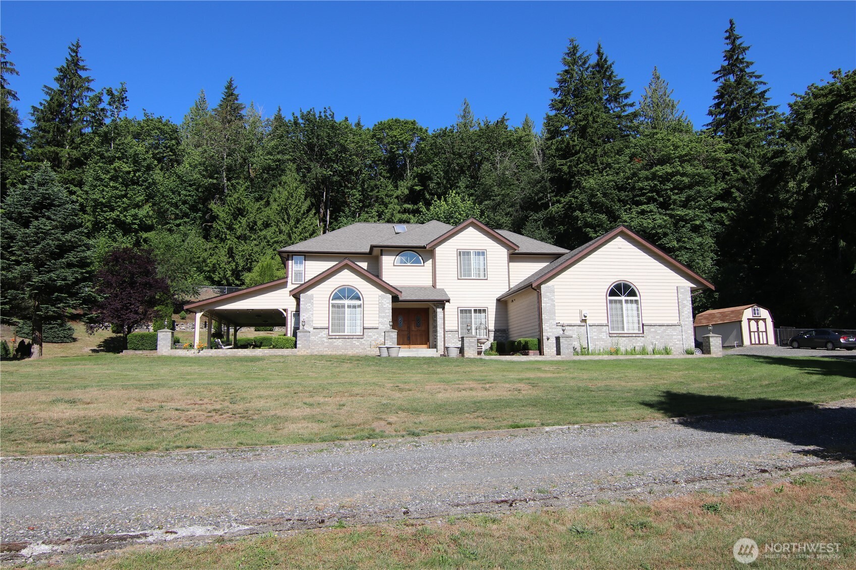 5860 Bell Creek Road Deming, WA 98244 - Photo 4 of 39 a view of a yard in front of a house with large trees