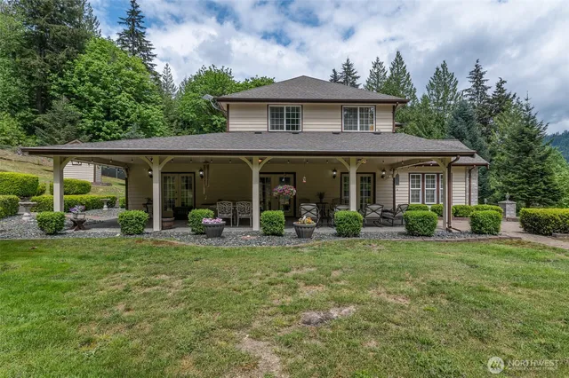 a front view of a house with a garden and porch
