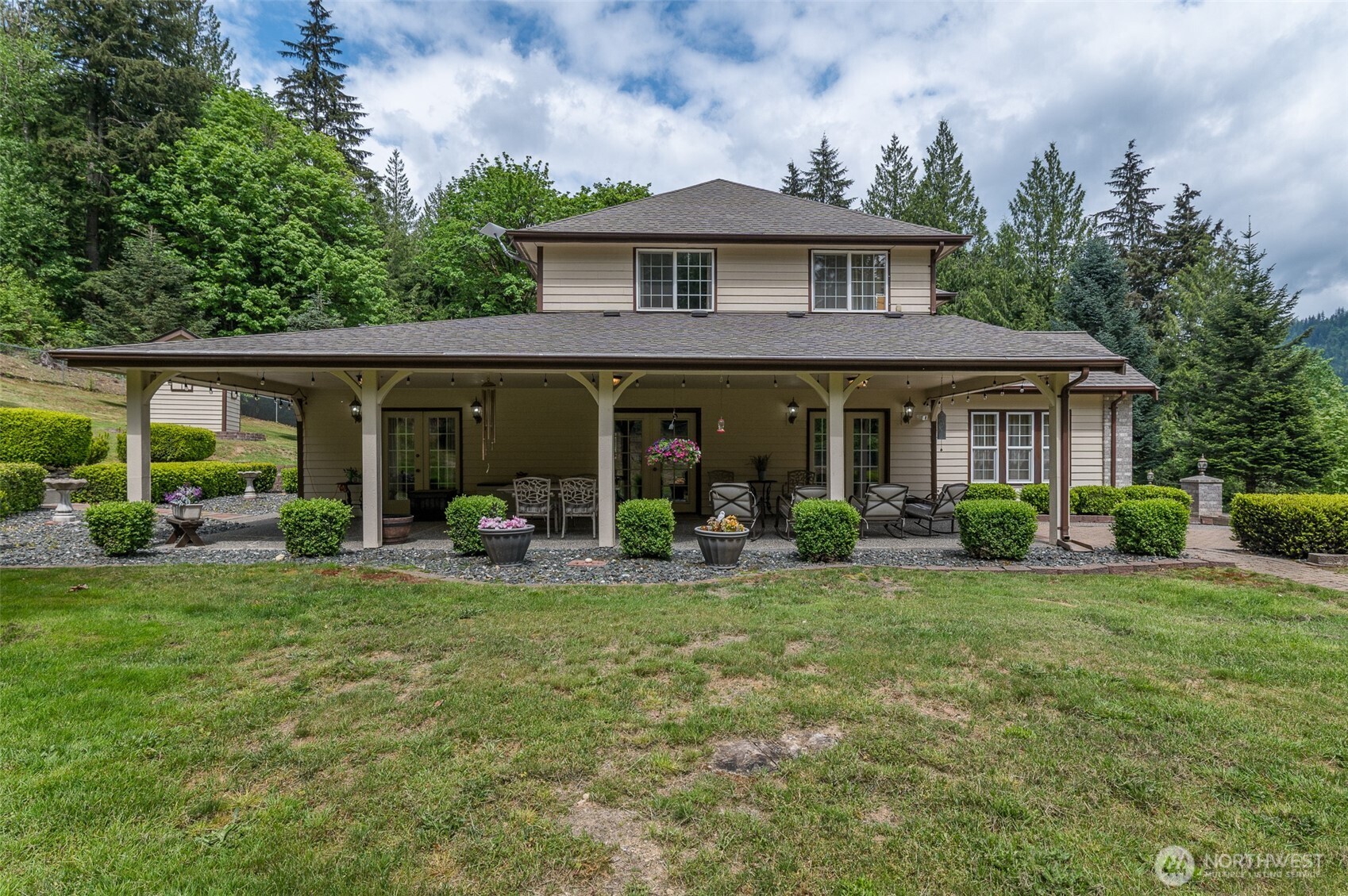 5860 Bell Creek Road Deming, WA 98244 - Photo 9 of 39 a front view of a house with a garden and porch
