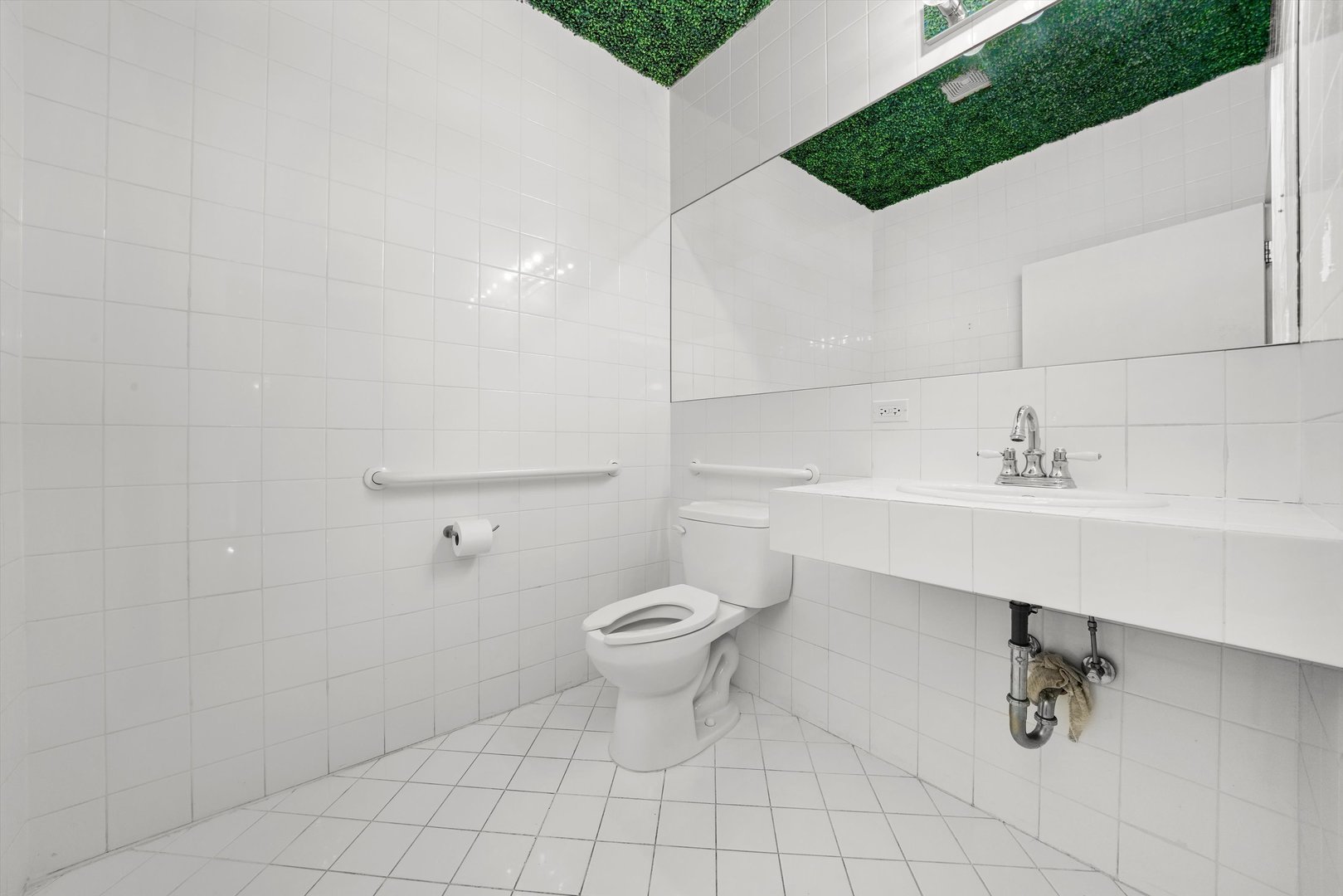 1412 West Division Street, Unit C1 Chicago, IL 60642 - Photo 24 of 28 a bathroom with a sink a toilet and a mirror