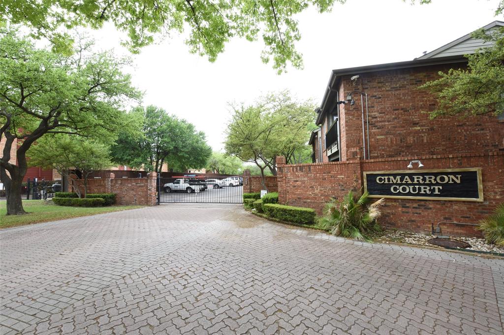 a view of a street with cars parked on the road
