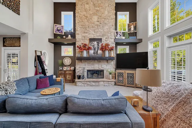 a living room with furniture fireplace and a window