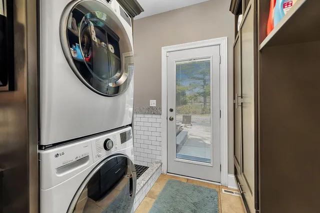 a en suite bathroom with a double vanity sink mirror and chandelier