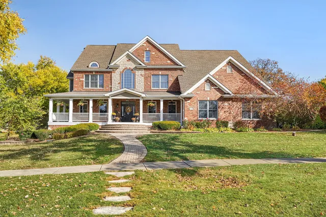 a front view of a house with a yard table and chairs