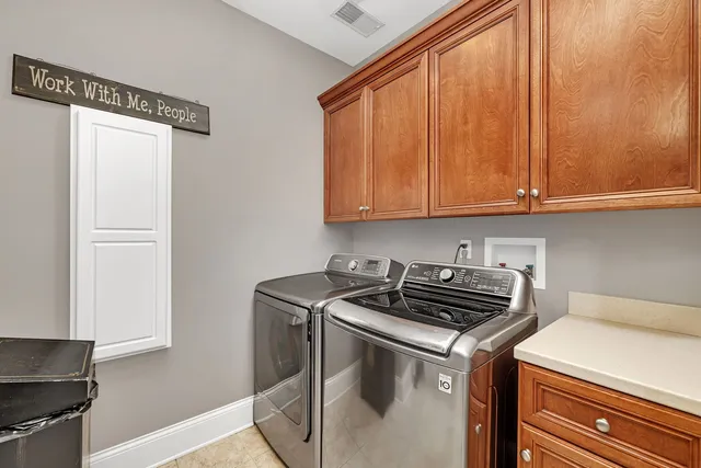 a living room with furniture a piano and a flat screen tv