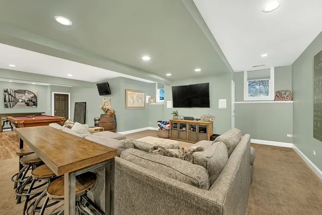 a view of a roof deck with table and chairs a barbeque with wooden floor and fence