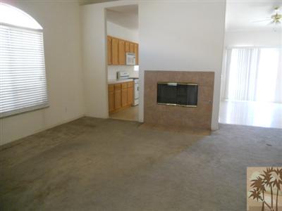 66120 Santa Rosa Road Desert Hot Springs, CA 92240 - Photo 2 of 9 an empty room with windows and fireplace