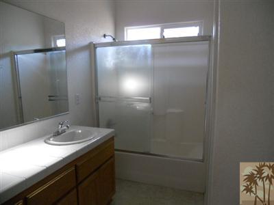66120 Santa Rosa Road Desert Hot Springs, CA 92240 - Photo 8 of 9 a bathroom with a sink shower and a mirror
