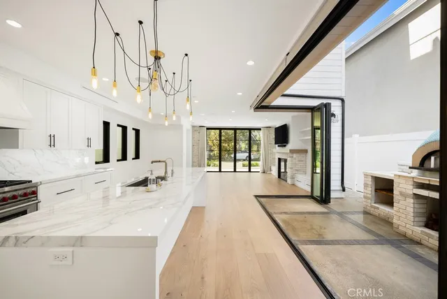 a view of a living room and kitchen with furniture large windows