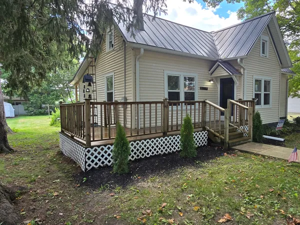 a view of house with backyard and deck