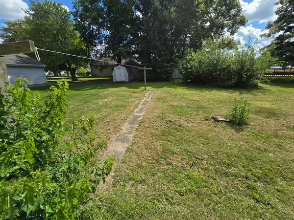 a view of a backyard with swimming pool