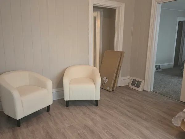 a living room with furniture and a potted plant