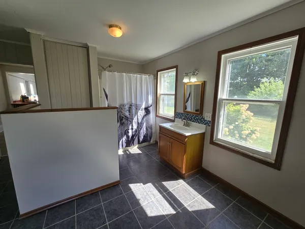 a bathroom with a sink a mirror and a window
