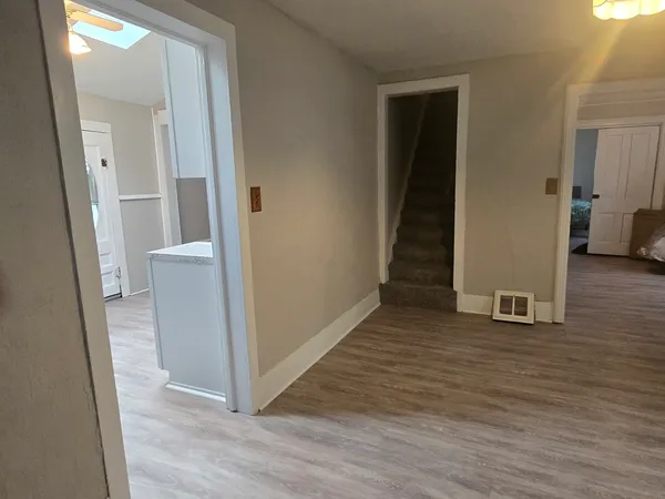 a kitchen with a sink cabinets and wooden floor
