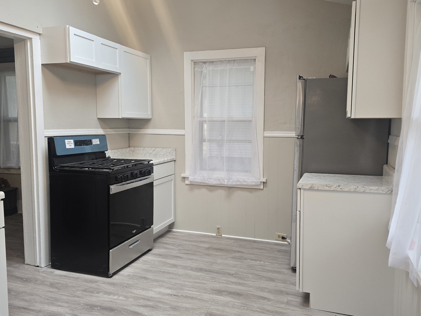 103 West Cherokee Avenue Shabbona, IL 60550 - Photo 32 of 42 a kitchen with a stove and a refrigerator