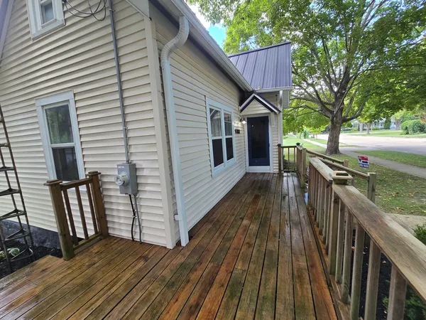 a view of a house with wooden deck