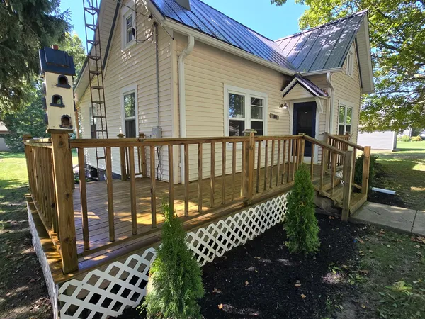a view of a house with backyard and sitting area