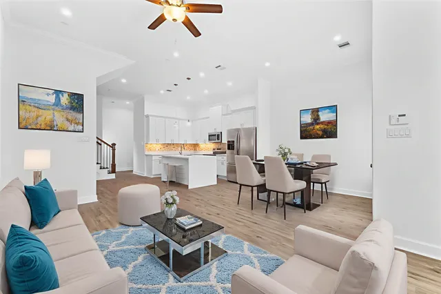 a living room with furniture kitchen view and a table
