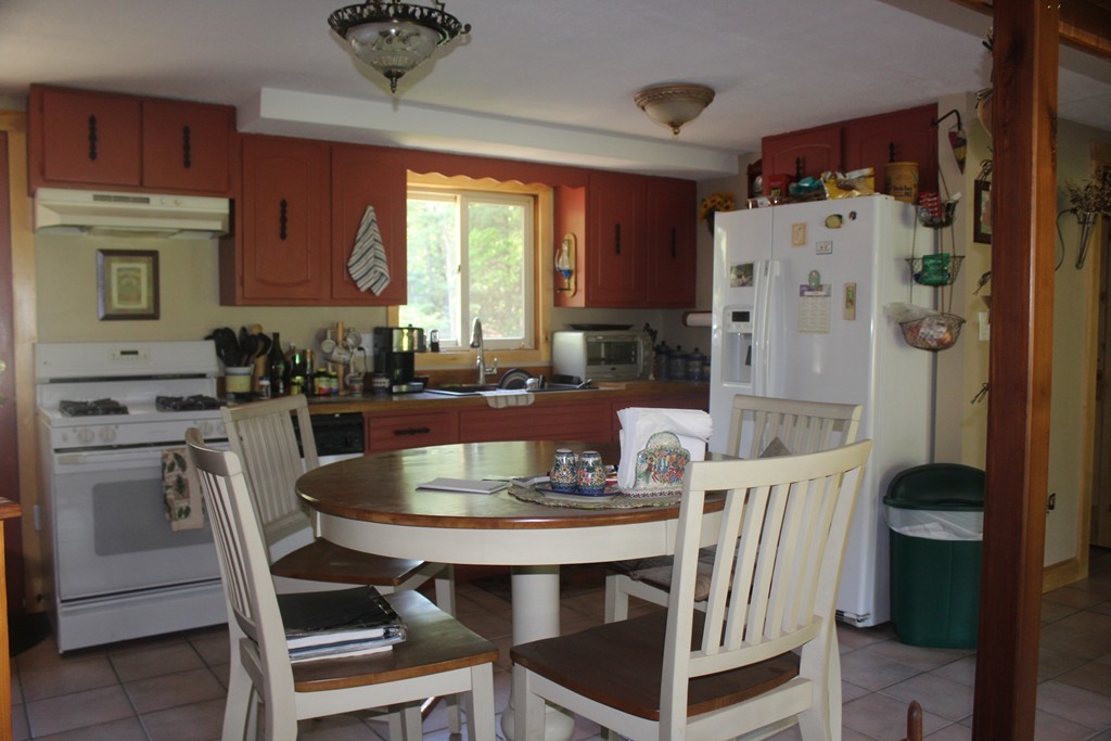 49 Quarry Road Granby, CT 06035 - Photo 17 of 25 a kitchen with a dining table and chairs