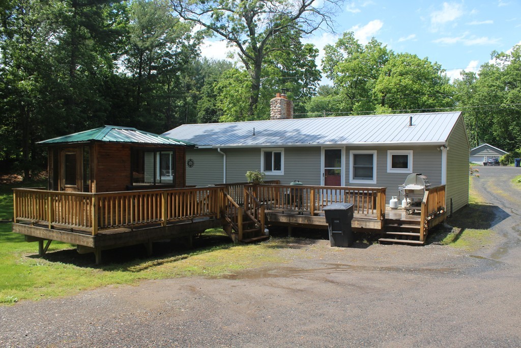 49 Quarry Road Granby, CT 06035 - Photo 2 of 25 a view of a house with a small deck and a yard