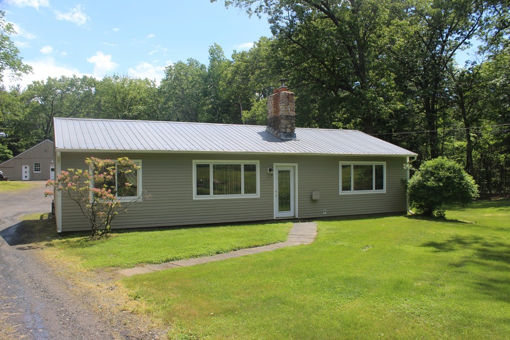 49 Quarry Road Granby, CT 06035 - Photo 5 of 25 a front view of a house with a yard