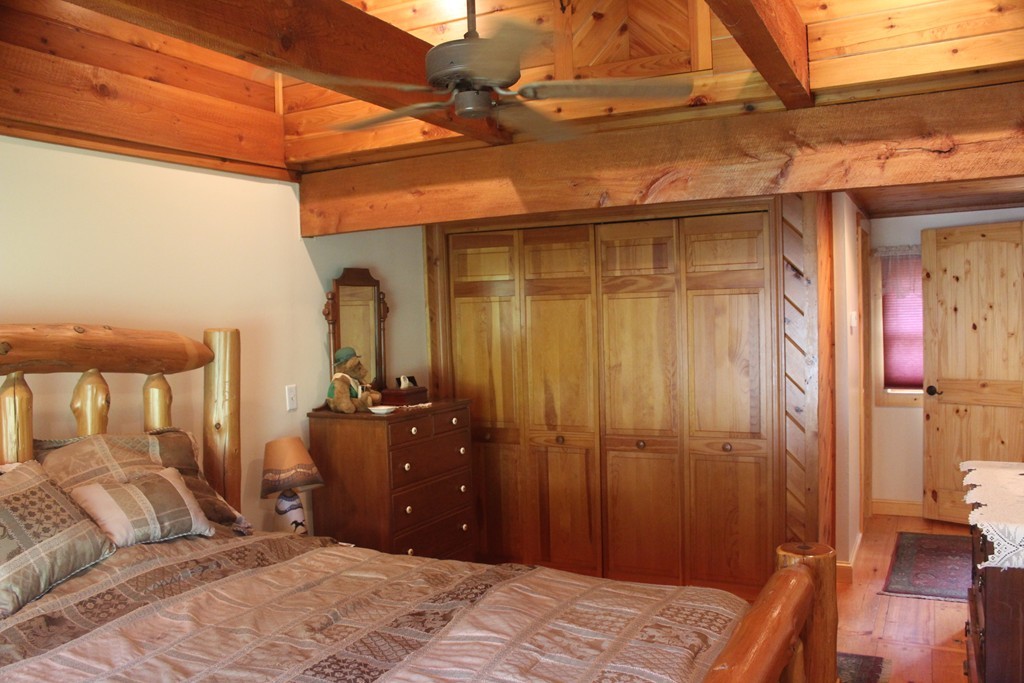 49 Quarry Road Granby, CT 06035 - Photo 8 of 25 a bedroom with a bed and wooden floor