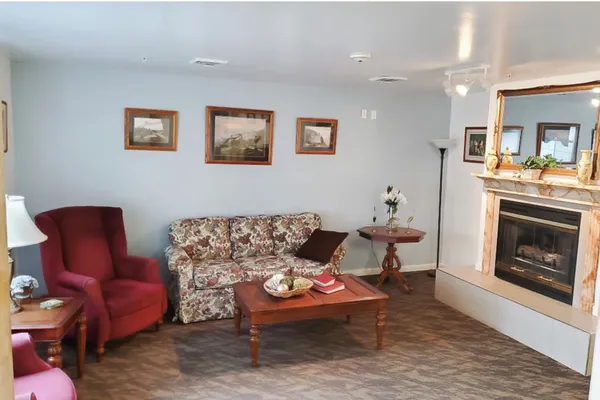 a living room with furniture a fireplace