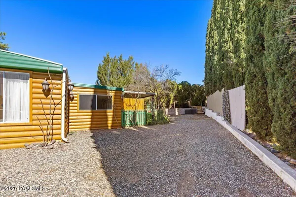 a view of a house with backyard and trees