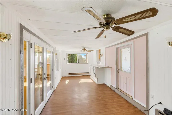 a view of a livingroom with a ceiling fan and window