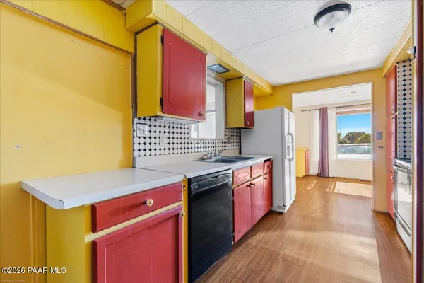 a kitchen with stainless steel appliances granite countertop a sink and a stove