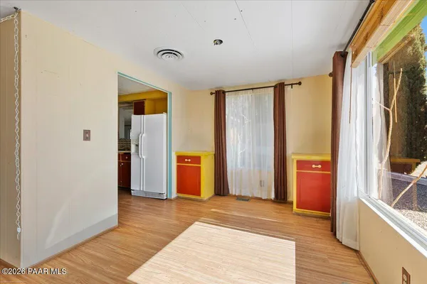 a view of a hallway with wooden floor and furniture