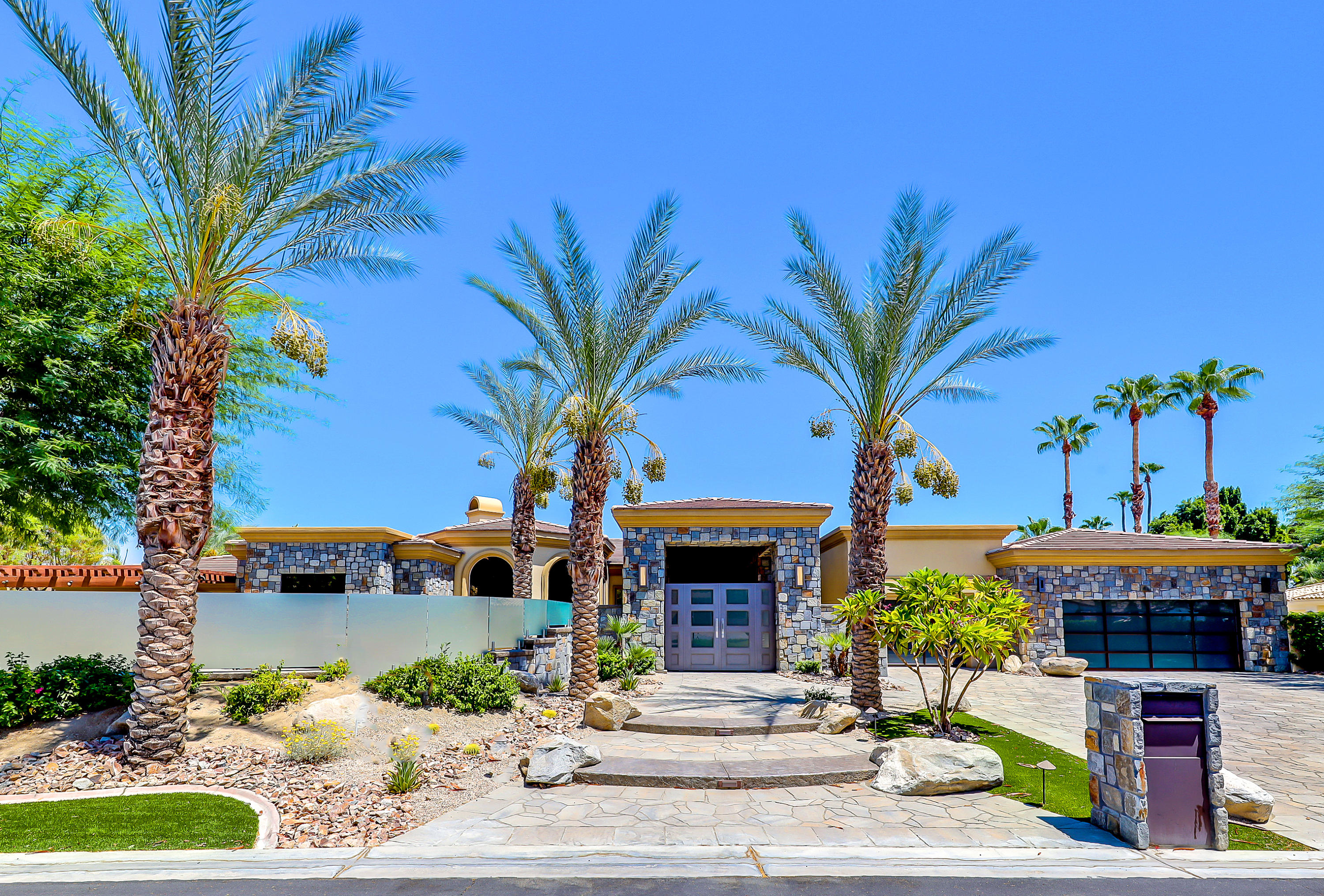 28 Clancy Lane South Rancho Mirage, CA 92270 - Photo 1 of 30 a front view of a house with garden and patio