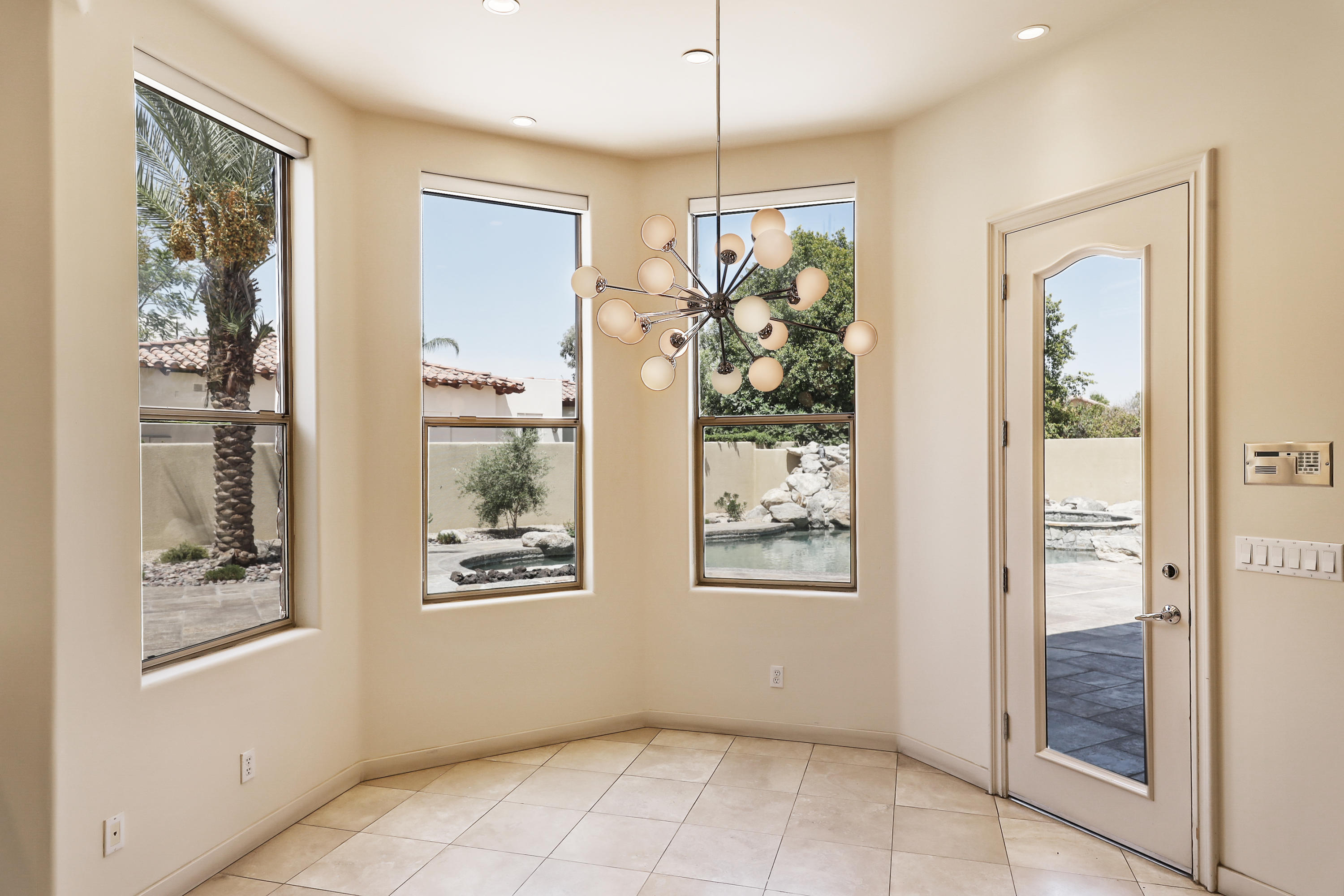 28 Clancy Lane South Rancho Mirage, CA 92270 - Photo 16 of 30 a view of an entryway with wooden floor and a chandelier
